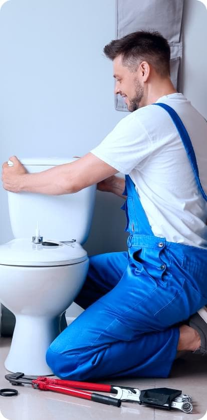 Worker is fixing a toilet